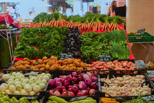 A vertical shot of the bazaar full of different vegetables
